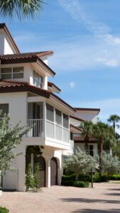 Beautiful beachfront home in Florida City with lush palm trees and clear skies.